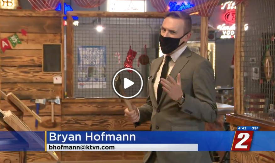 Reporter Bryan Hofmann throwing axe